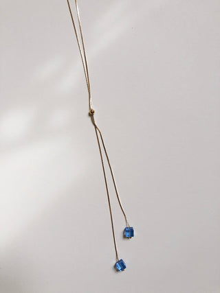 Gold lariat necklace 38" with sapphire glass detail