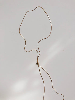 Gold lariat necklace 38" with sapphire glass detail